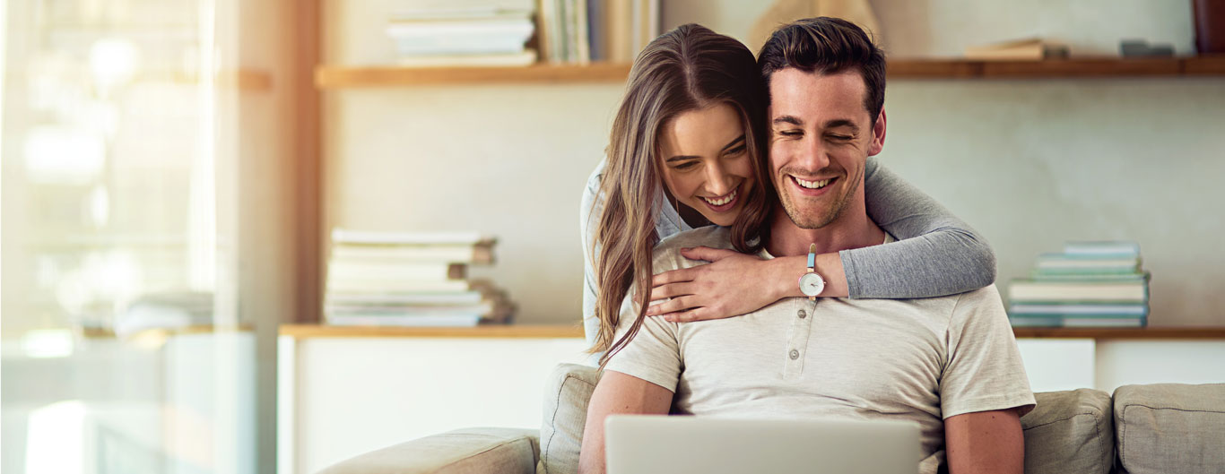 woman and man looking at laptop